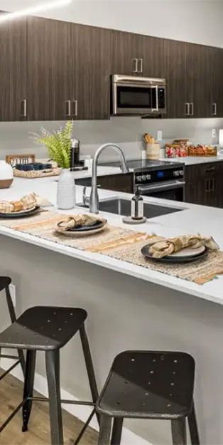a modern kitchen with bar stools