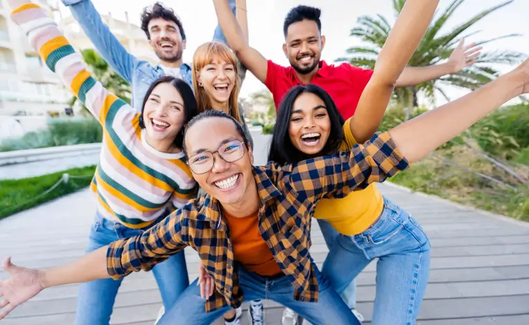 a diverse group of students smiling outside