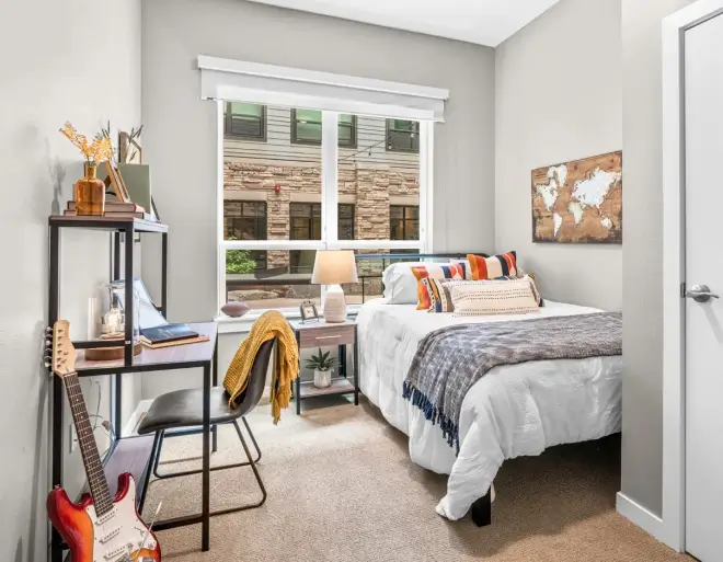 a furnished apartment bedroom with a study desk