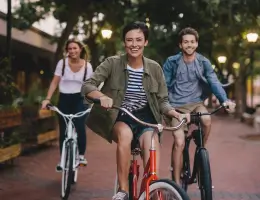three young adults riding bicycles