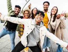 a diverse group of students smiling outside